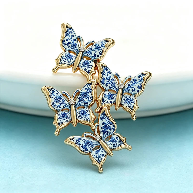 Blue and white patterned butterfly brooch on a pale blue background