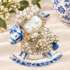 Blue and White Rocking Horse Lamb Brooch on a complementary display background