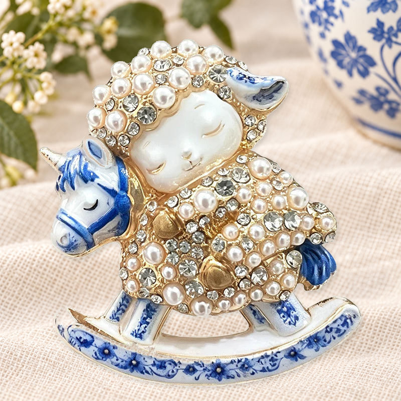 Blue and White Rocking Horse Lamb Brooch on a complementary display background