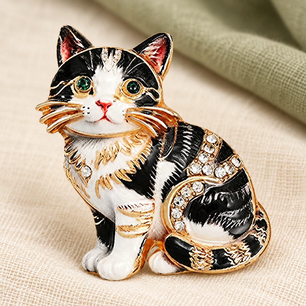 Seated Kitten with Rhinestone Accents Brooch — styled background
