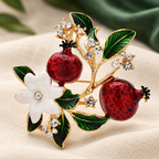 Enamel Pomegranate Branch with Flowers Brooch — styled background