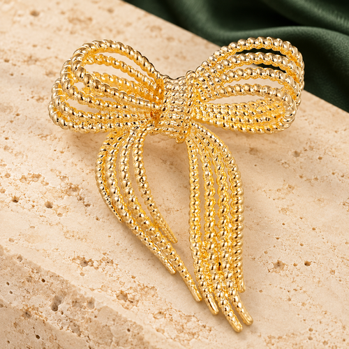 Beaded Ribbon Bow Brooch — styled background