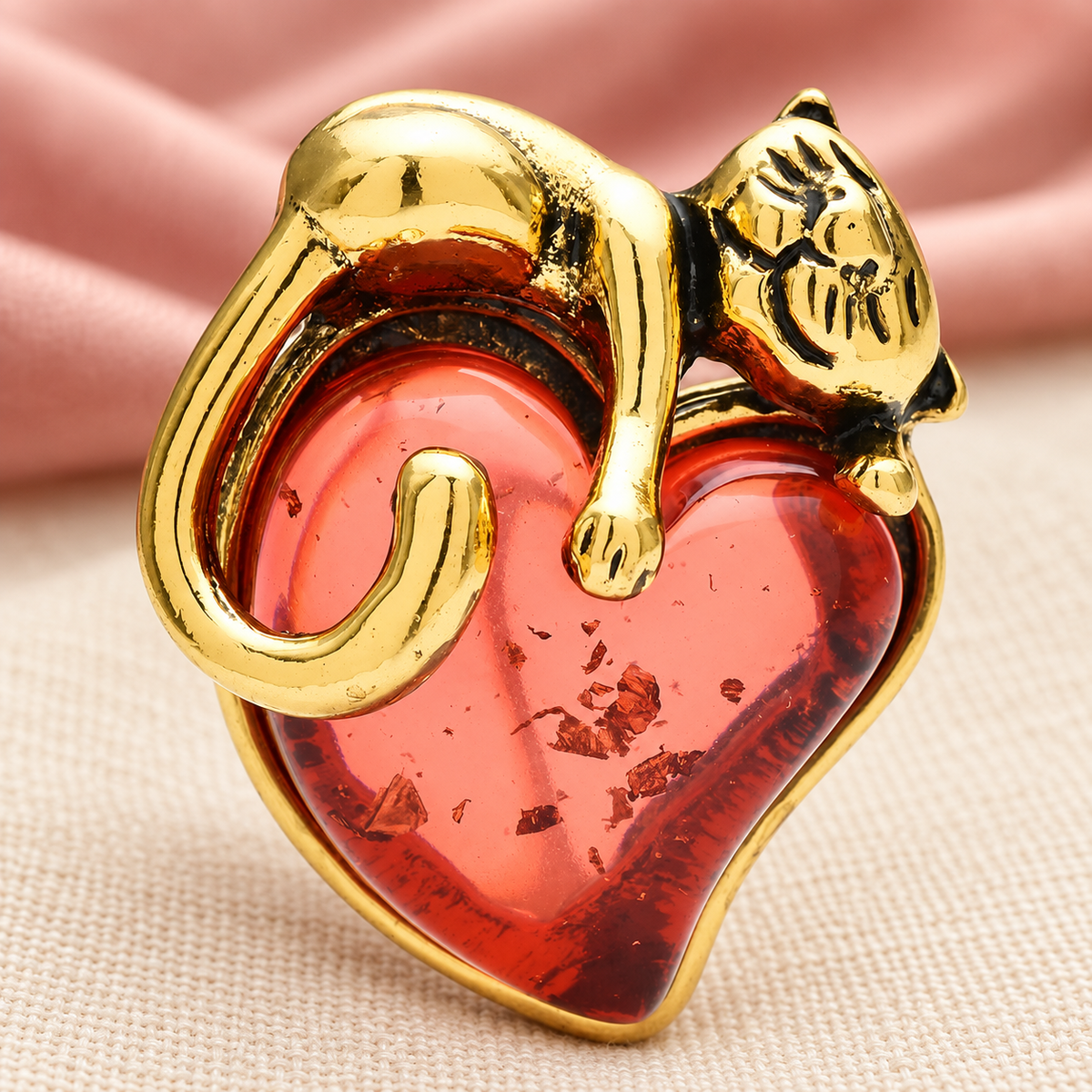 Cat Curled Around a Heart Brooch — styled background