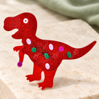 Glitter Acrylic Dinosaur Brooch — styled background