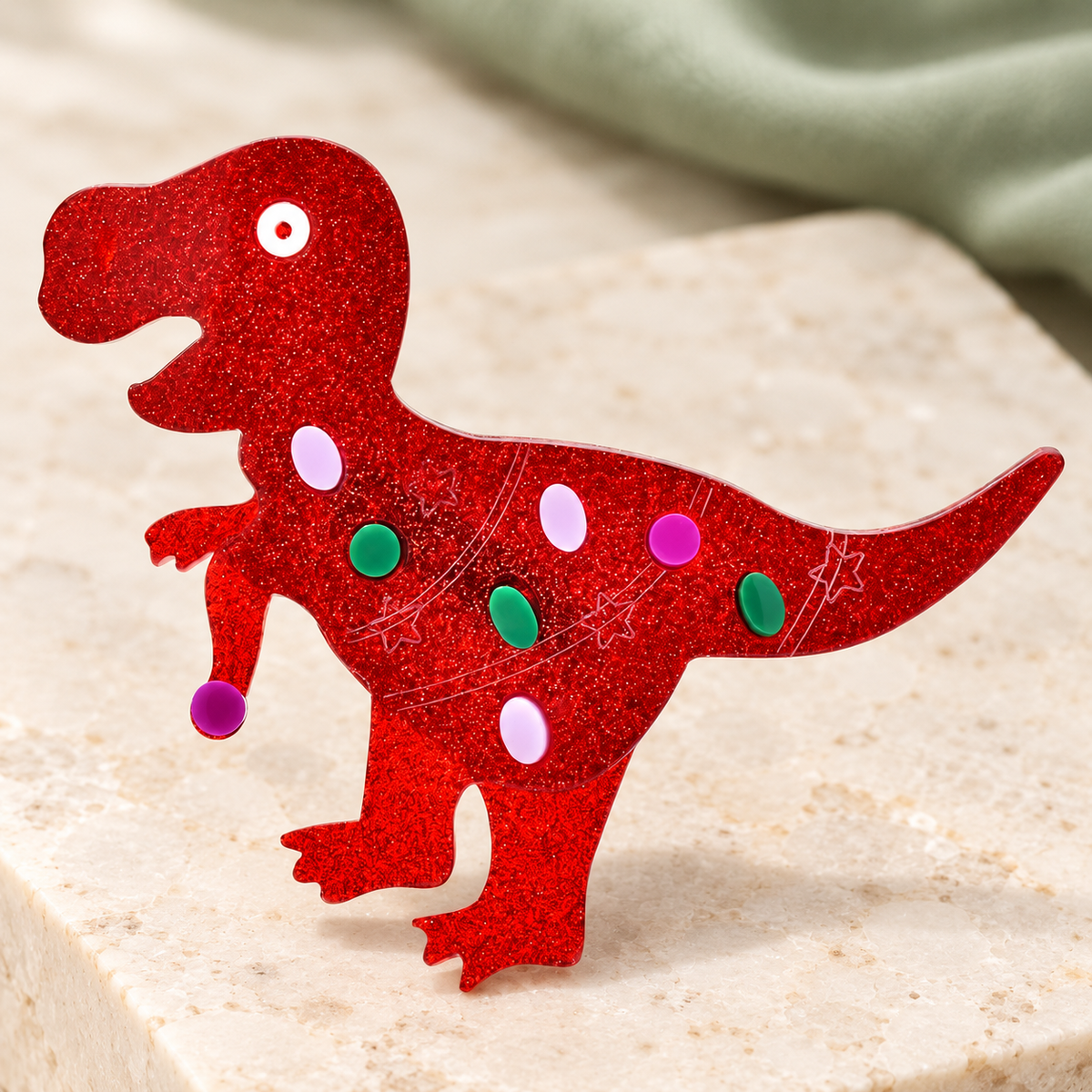 Glitter Acrylic Dinosaur Brooch — styled background