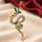 Rose and Coiled Snake Brooch — styled background