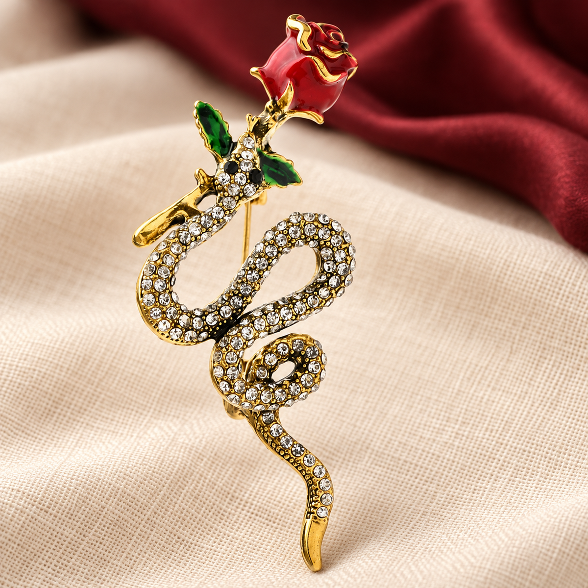 Rose and Coiled Snake Brooch — styled background