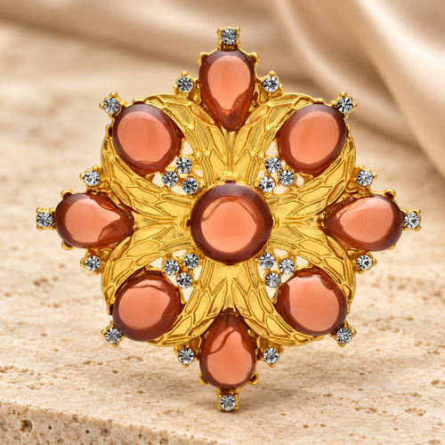 Amber-Tone Faceted Floral Medallion Brooch — styled background