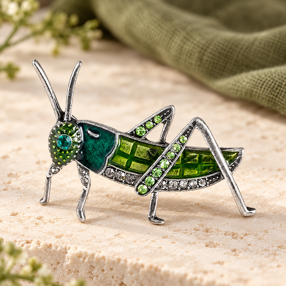 Green Enamel Grasshopper with Rhinestones Brooch — styled background