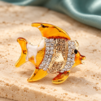 Golden Yellow Enamel Fish with Rhinestones Brooch — styled background