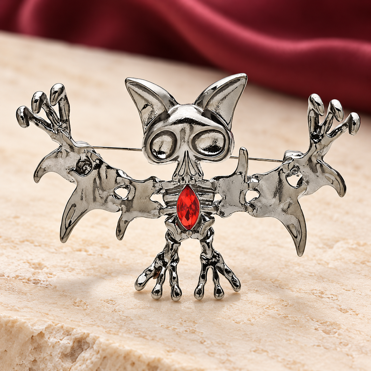 Playful Bat with Red Faceted Stone Brooch — styled background