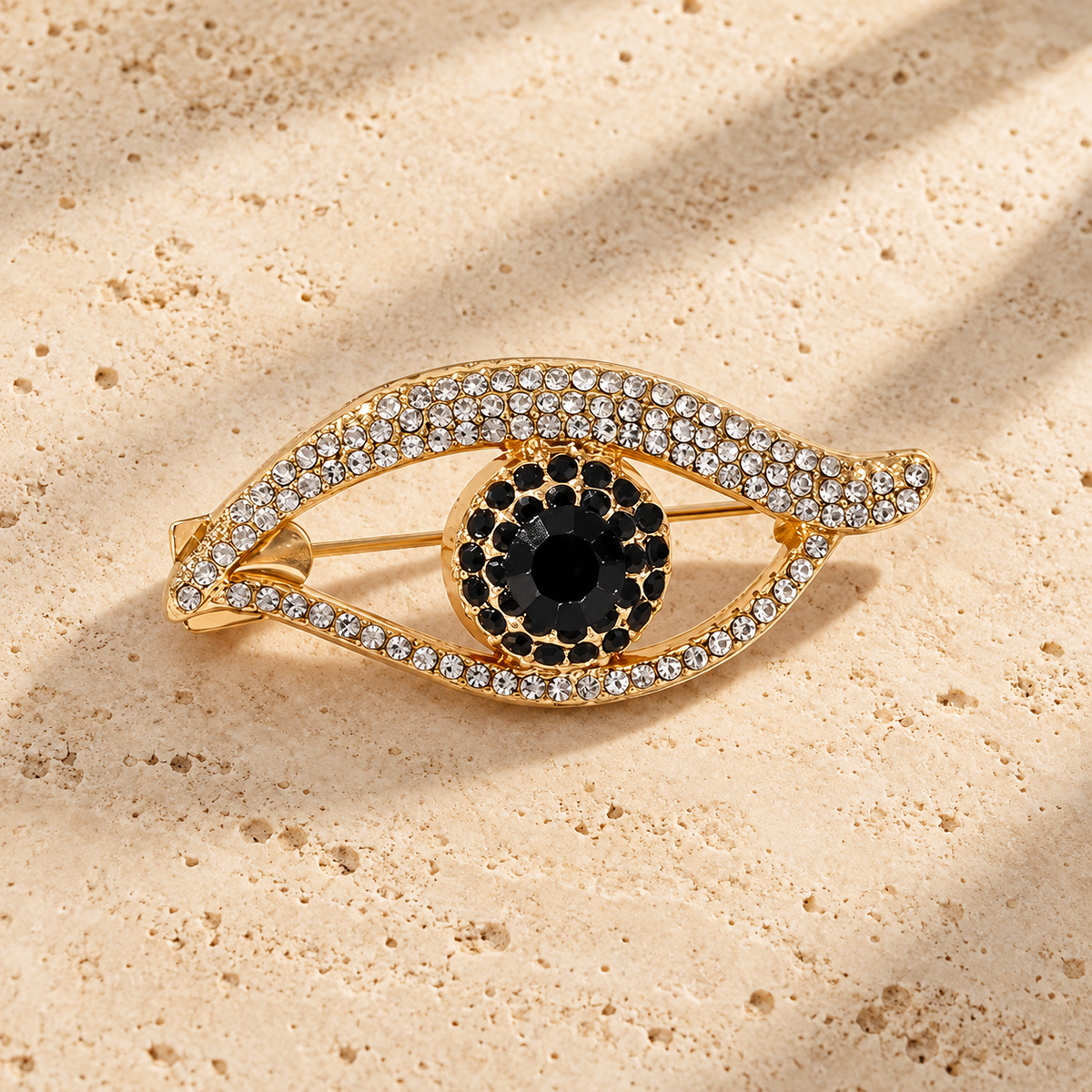 Rhinestone Eye with Black Iris Brooch — styled background