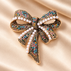 Vintage-Style Rhinestone Bow with Pearl-Look Beads Brooch — styled background