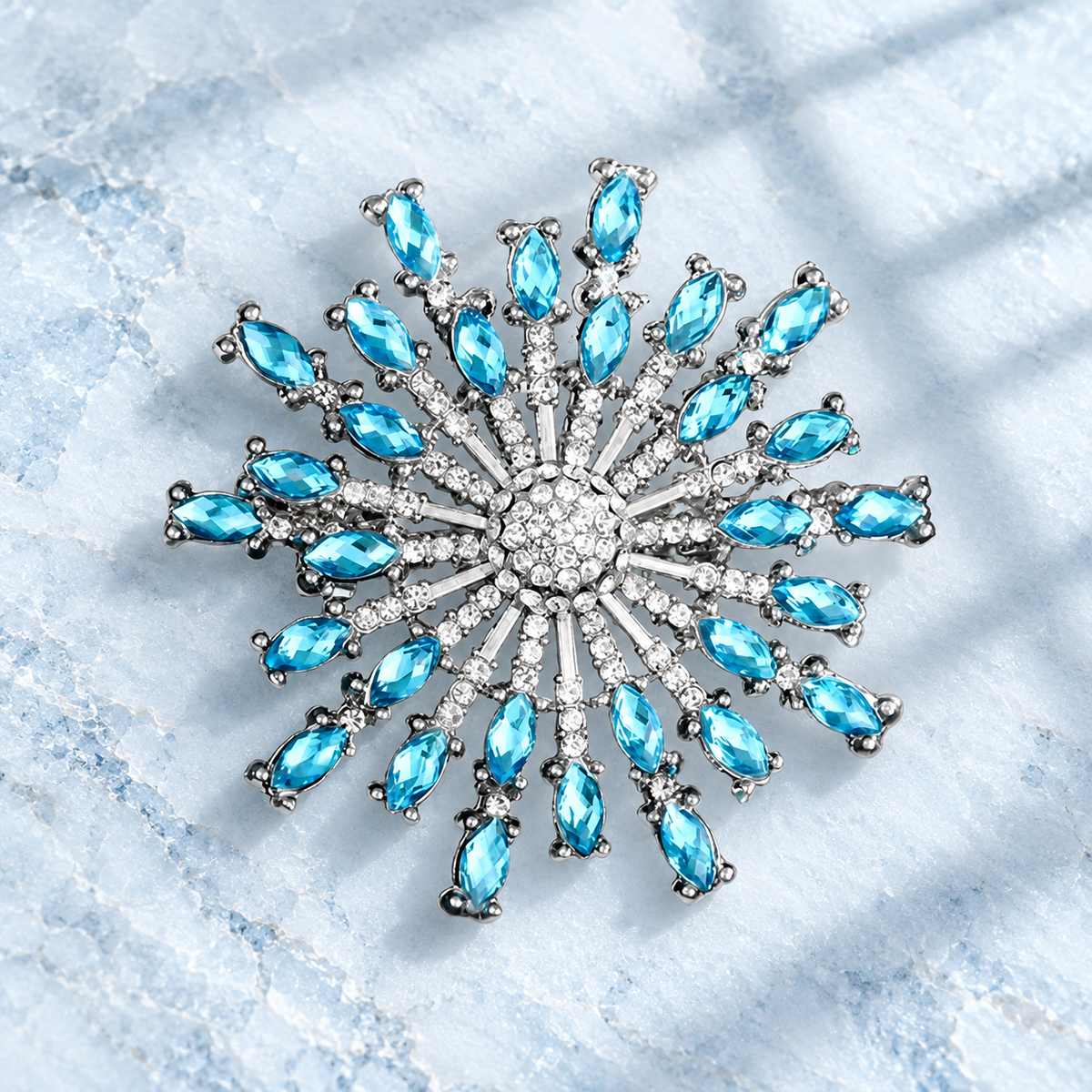 Faceted Rhinestone Sunburst Brooch — styled background
