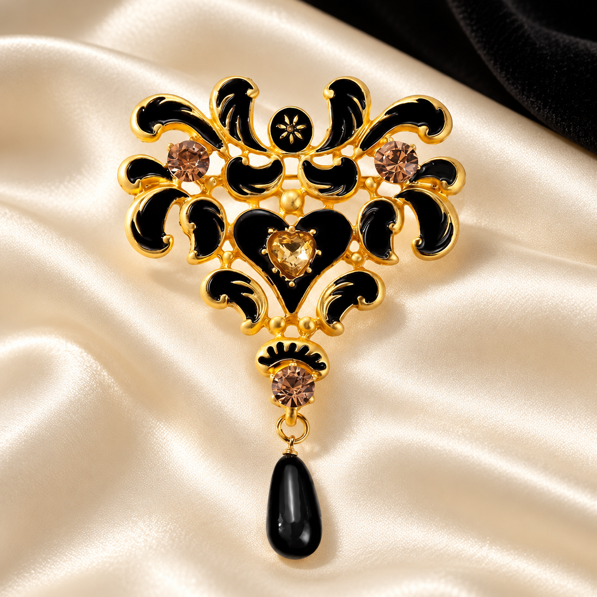Black Enamel Floral Scroll with Teardrop Brooch — styled background
