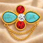 Faceted Floral Cross with Draped Chains Brooch — styled background