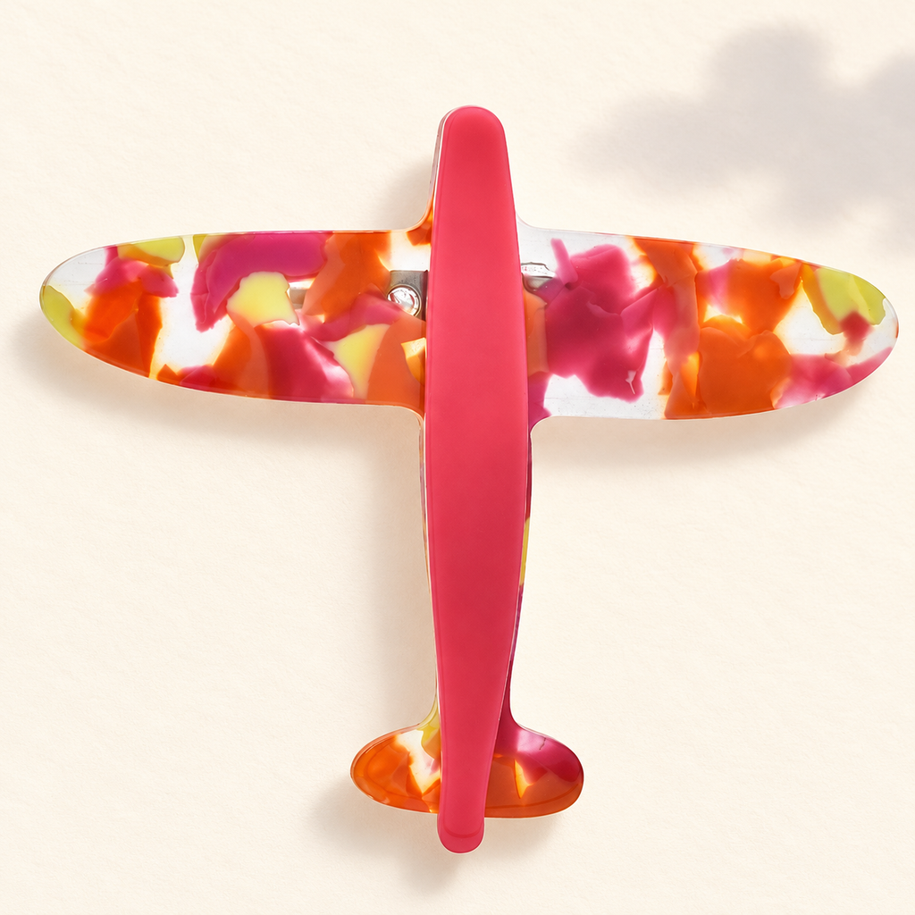 Marbled Acrylic Airplane Brooch — styled background
