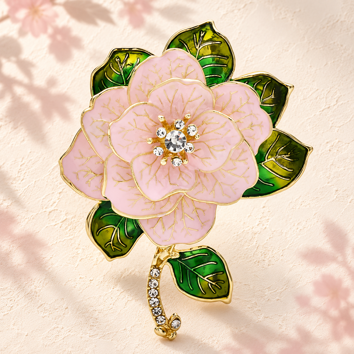 Enamel Camellia with Green Leaves Brooch — styled background