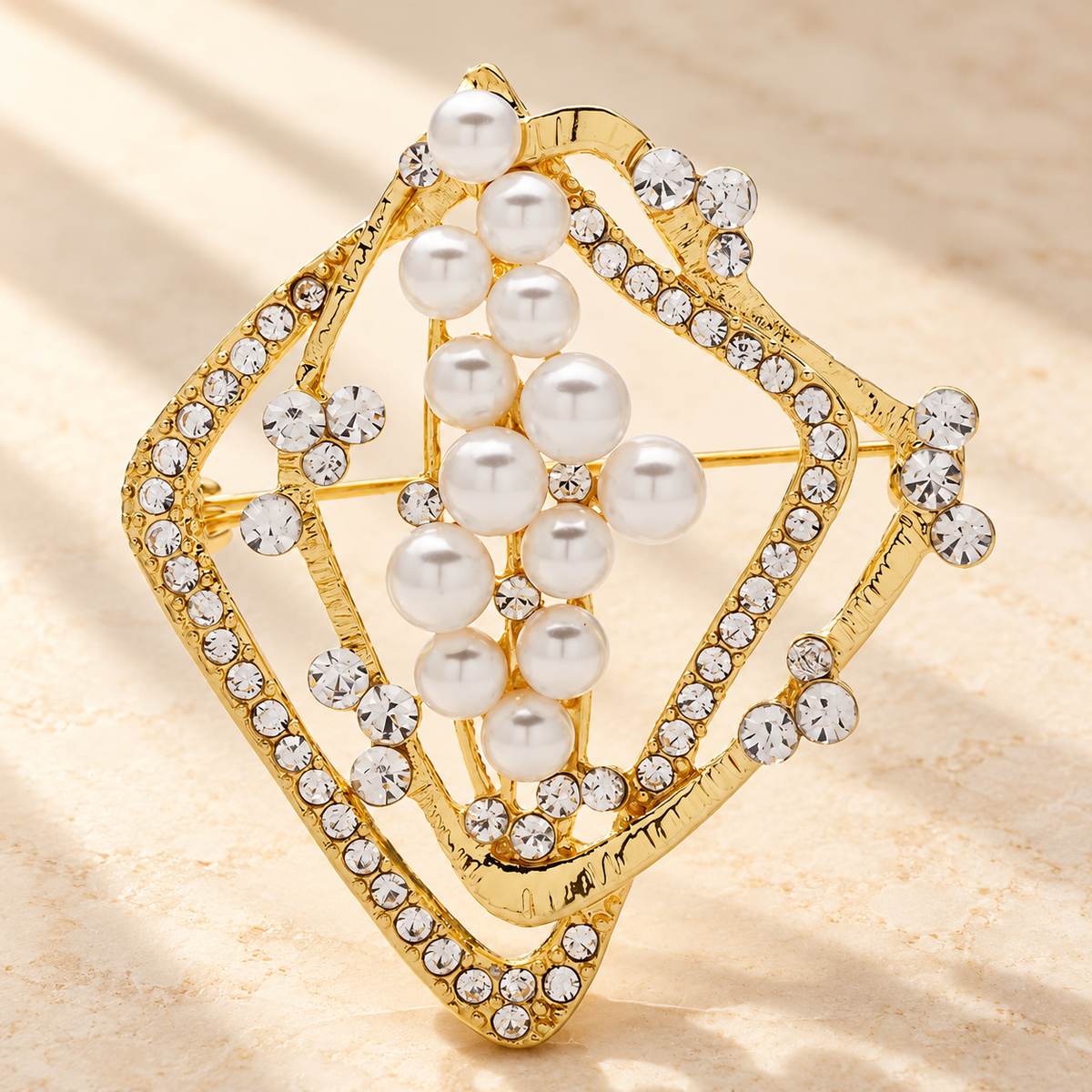 Geometric Diamond Frame with Pearl-Look Beads Brooch — styled background