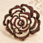 Openwork Rhinestone Rose Brooch — styled background