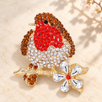 Red-Breasted Rhinestone Bird on Blossom Branch Brooch — styled background
