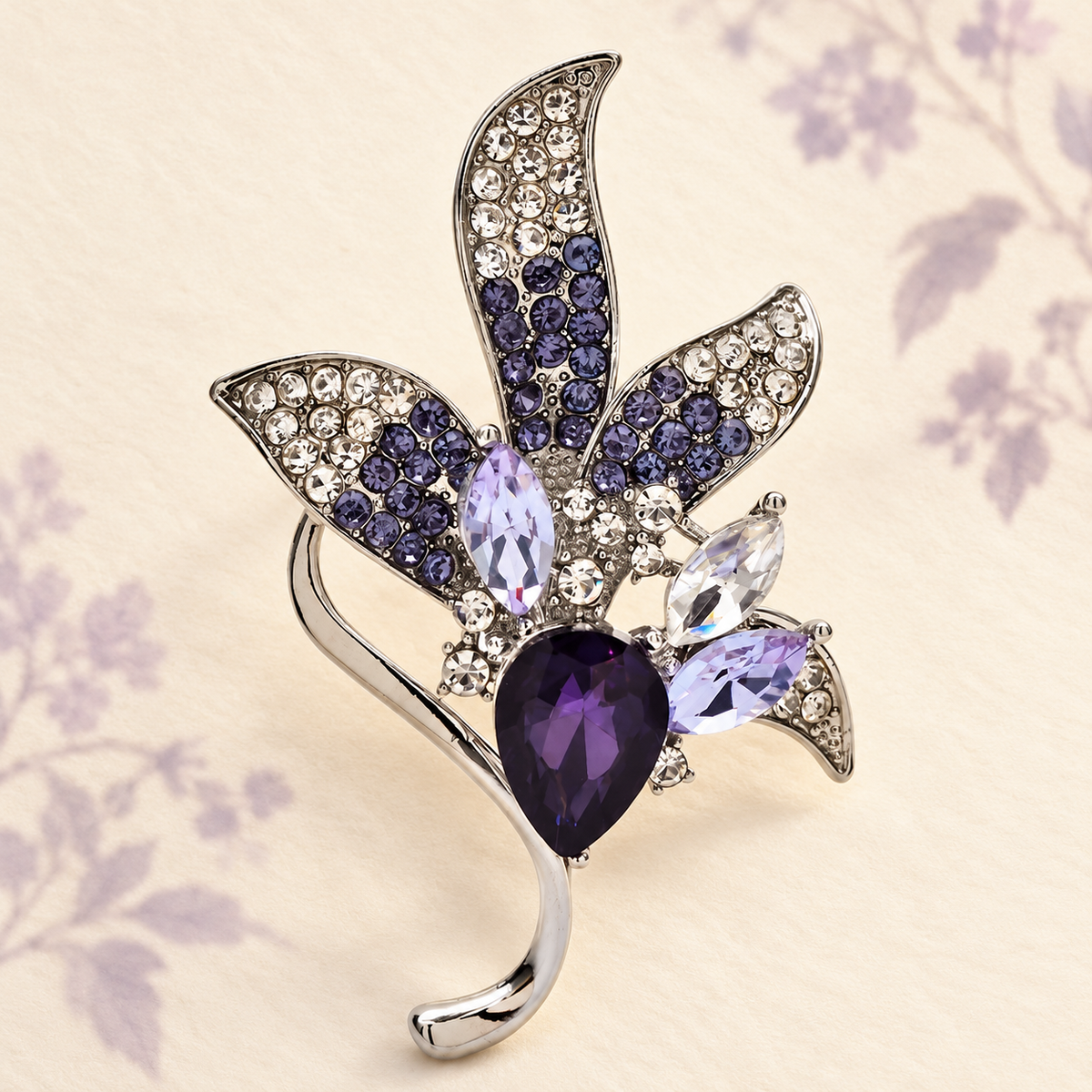 Purple Faceted Floral Spray with Curved Leaves Brooch — styled background
