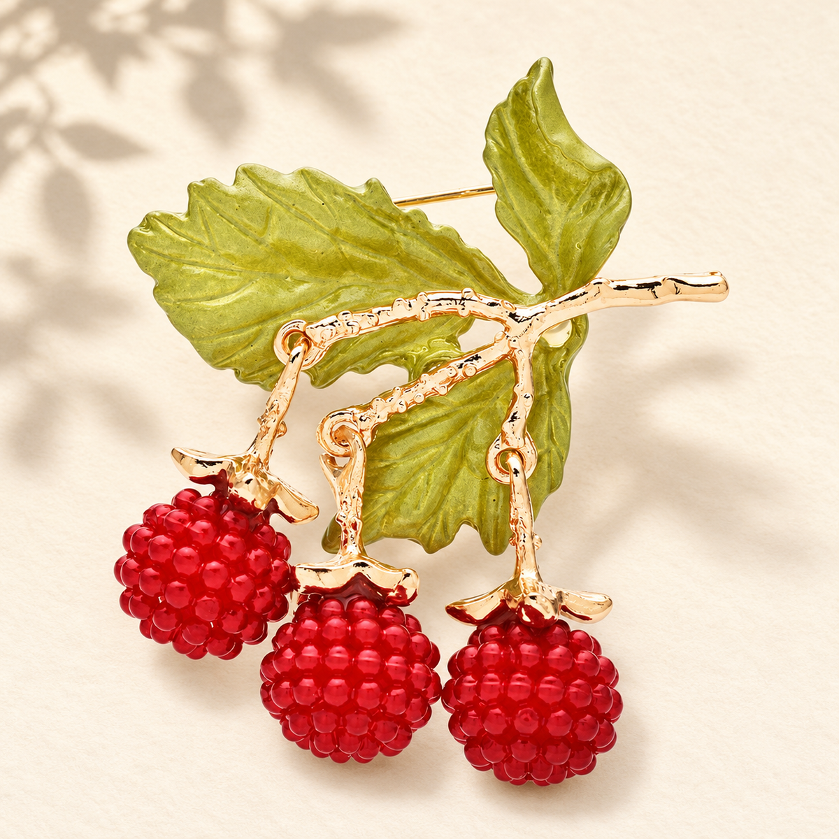 Enamel Berry Branch with Dangling Fruit Brooch — styled background