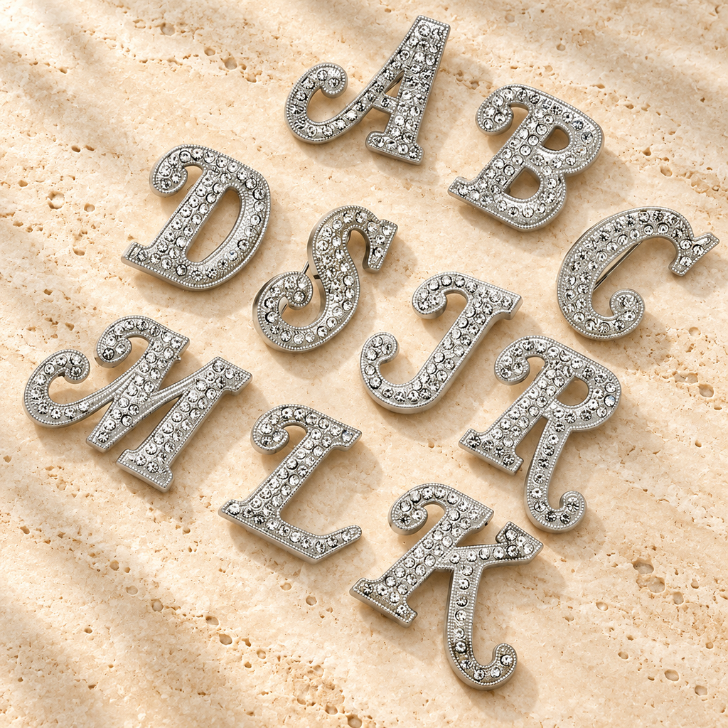 Rhinestone Script Initial Letter Brooch — styled background