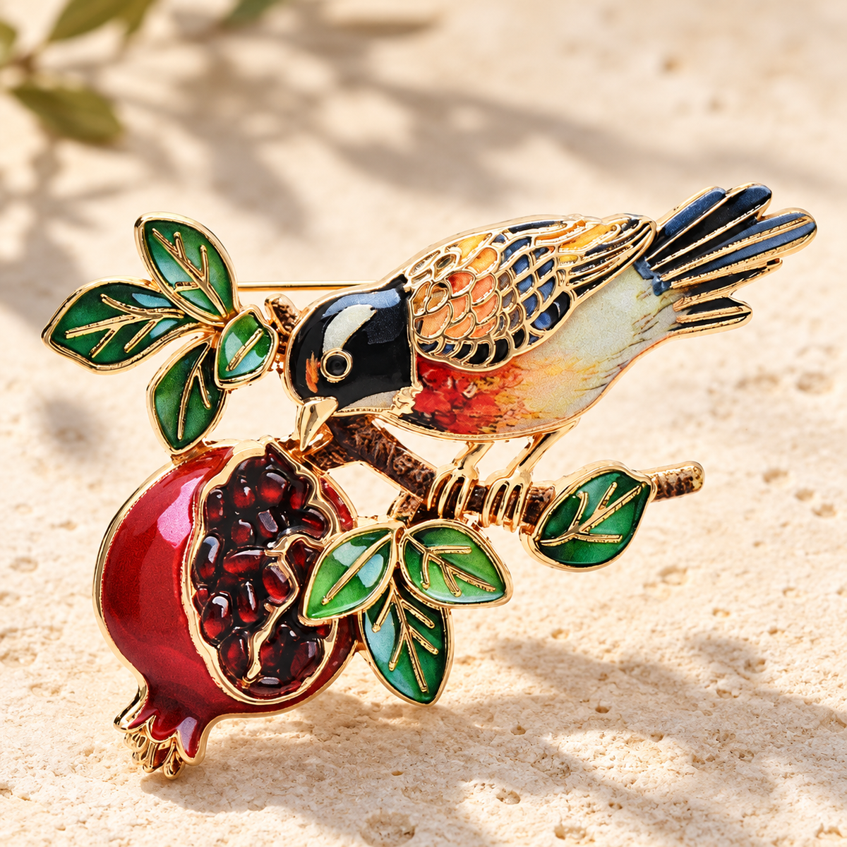 Enamel Bird on Pomegranate Branch Brooch — styled background
