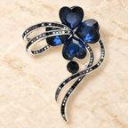 Faceted Heart-Petal Flower with Ribbon Trails Brooch — styled background