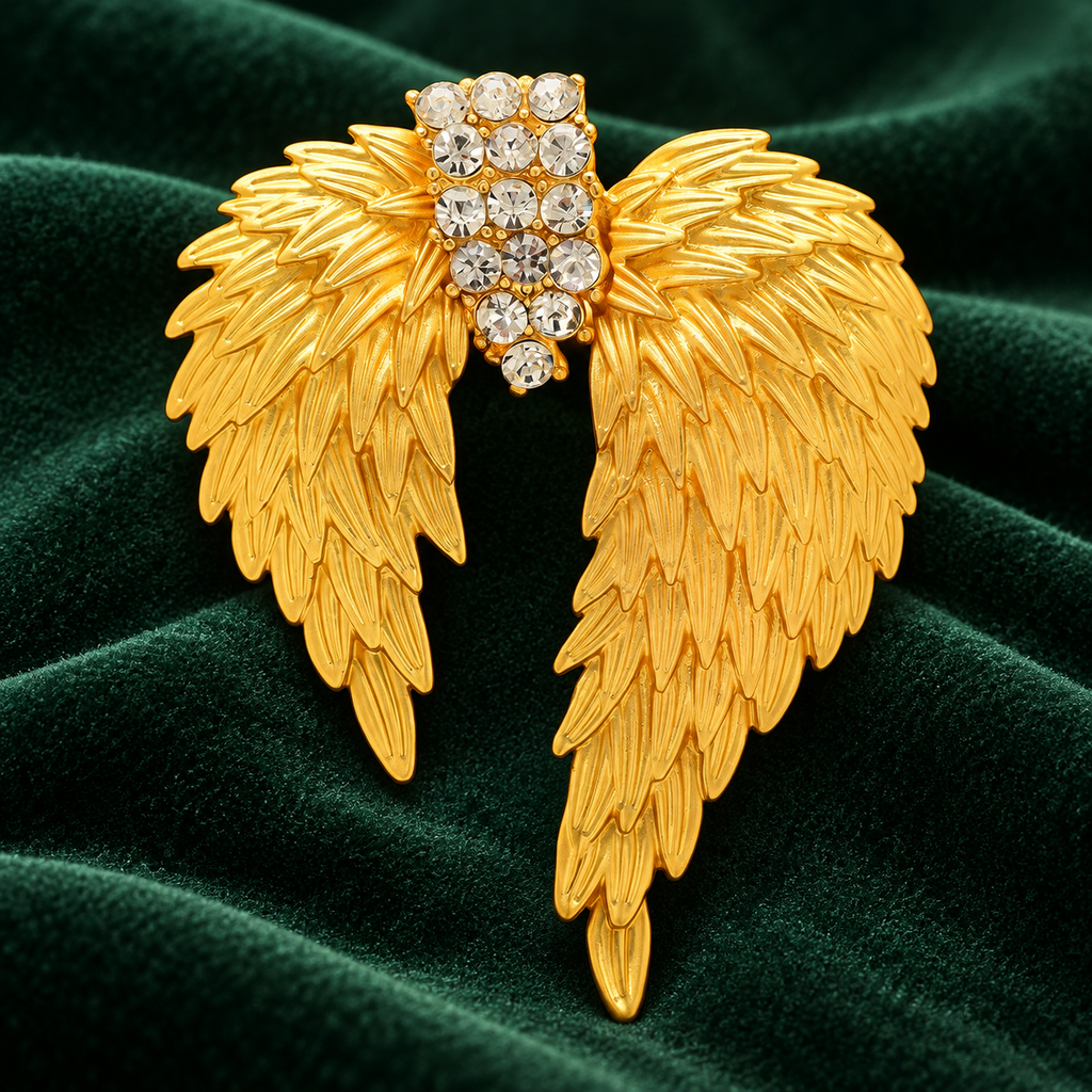 Golden Feather Wings with Rhinestone Center Brooch — styled background
