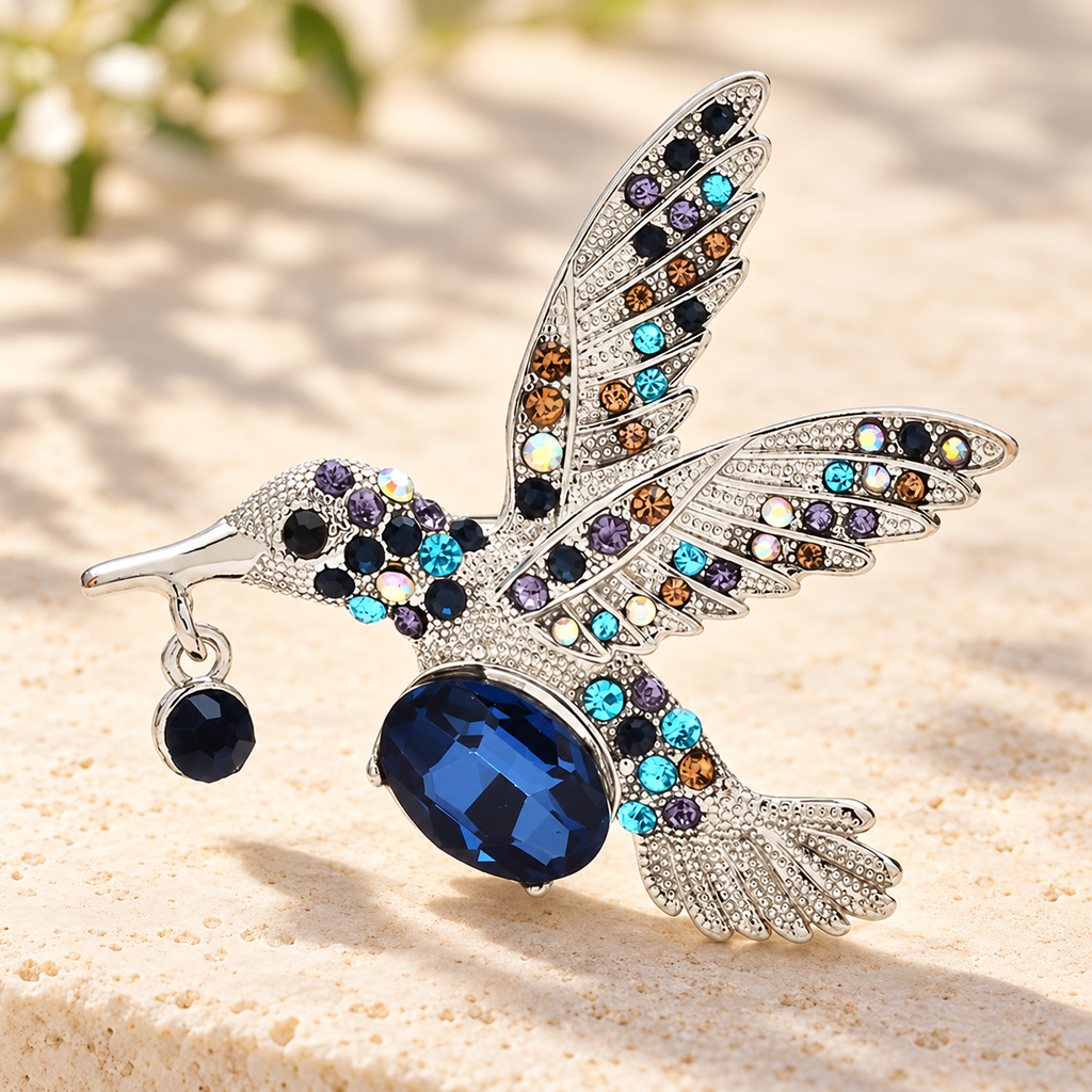 Faceted Hummingbird in Flight Brooch — styled background
