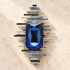 Geometric Sunburst with Faceted Center Brooch — styled background