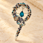 Coiled Rhinestone Snake Brooch — styled background