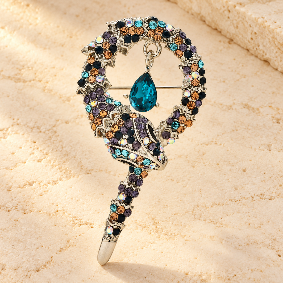 Coiled Rhinestone Snake Brooch — styled background
