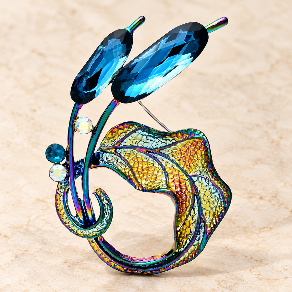 Blue Faceted Floral Swirl Brooch — styled background