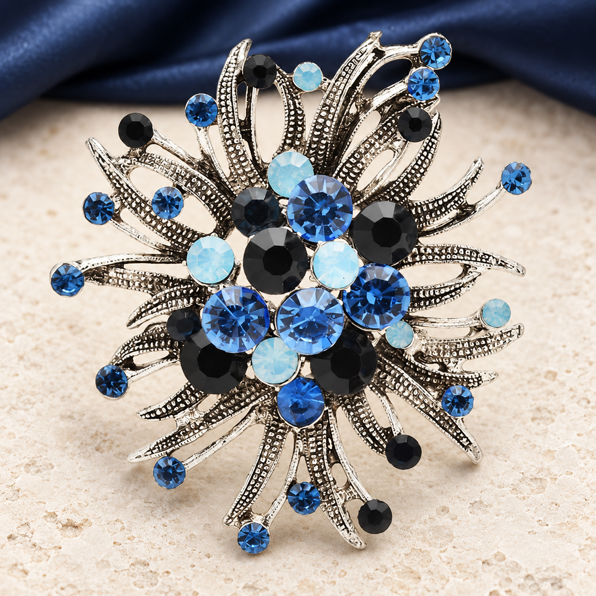 Vintage-Style Jeweled Flower with Curved Petals Brooch — styled background
