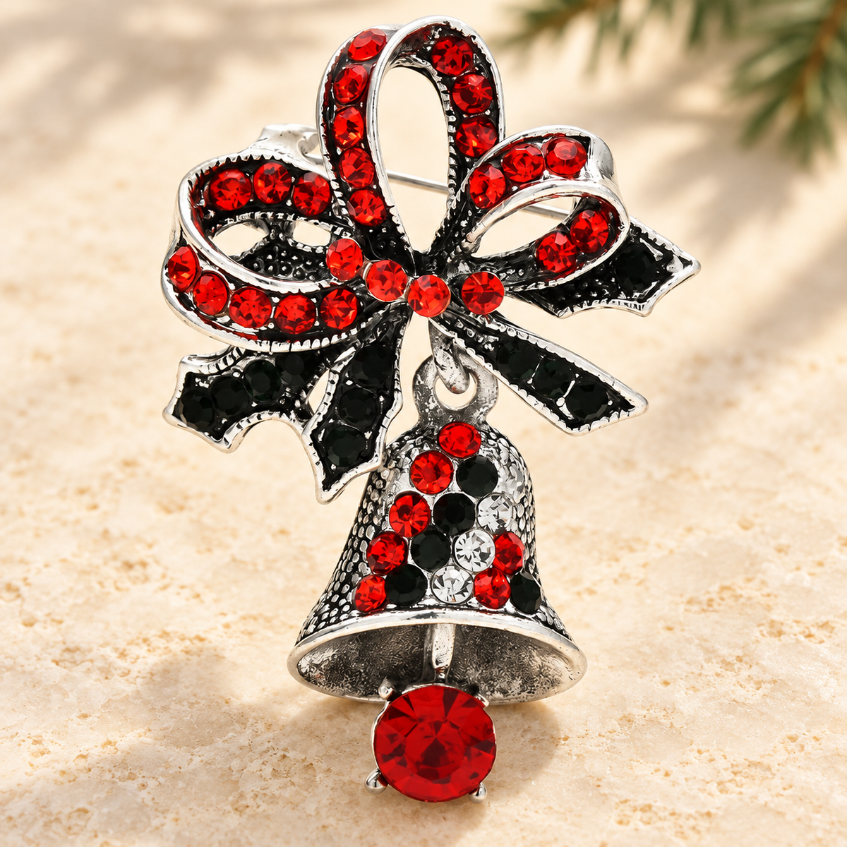 Jeweled Christmas Bell with Red Bow Brooch — styled background