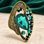 Geometric Teardrop with Faceted Center Brooch — styled background