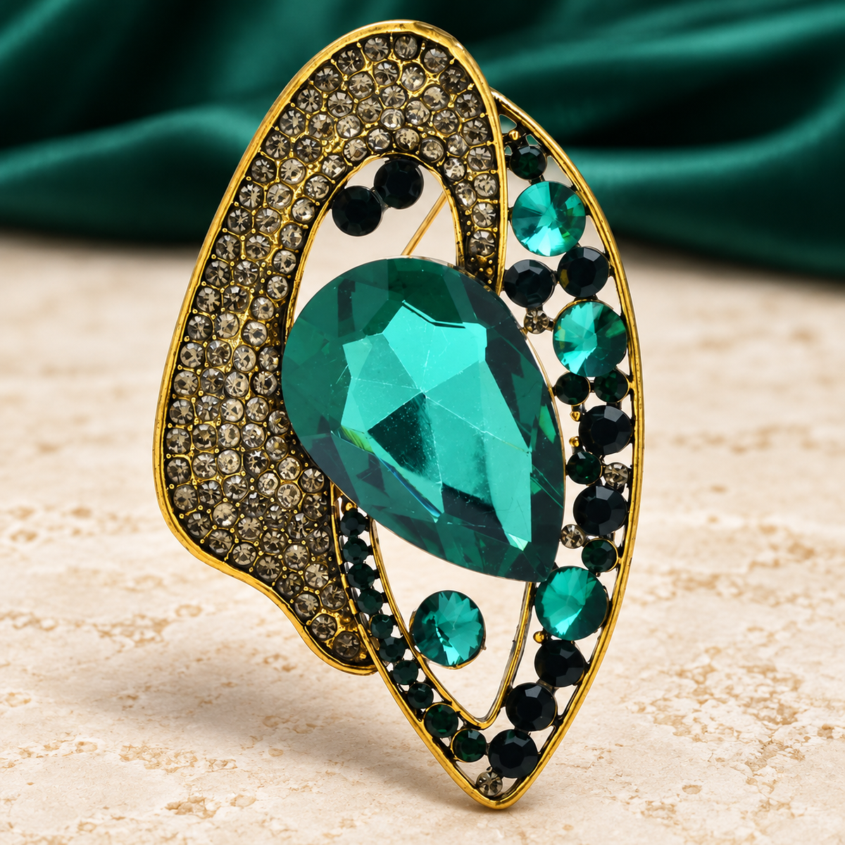 Geometric Teardrop with Faceted Center Brooch — styled background