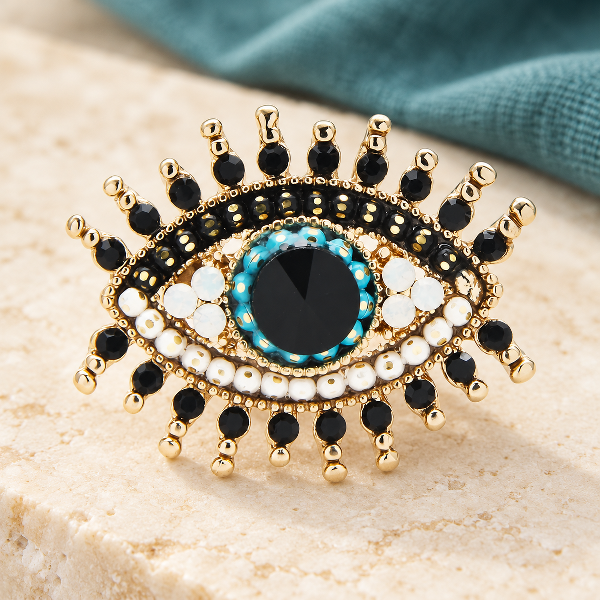 Jeweled Evil Eye with Rhinestone Lashes Brooch — styled background