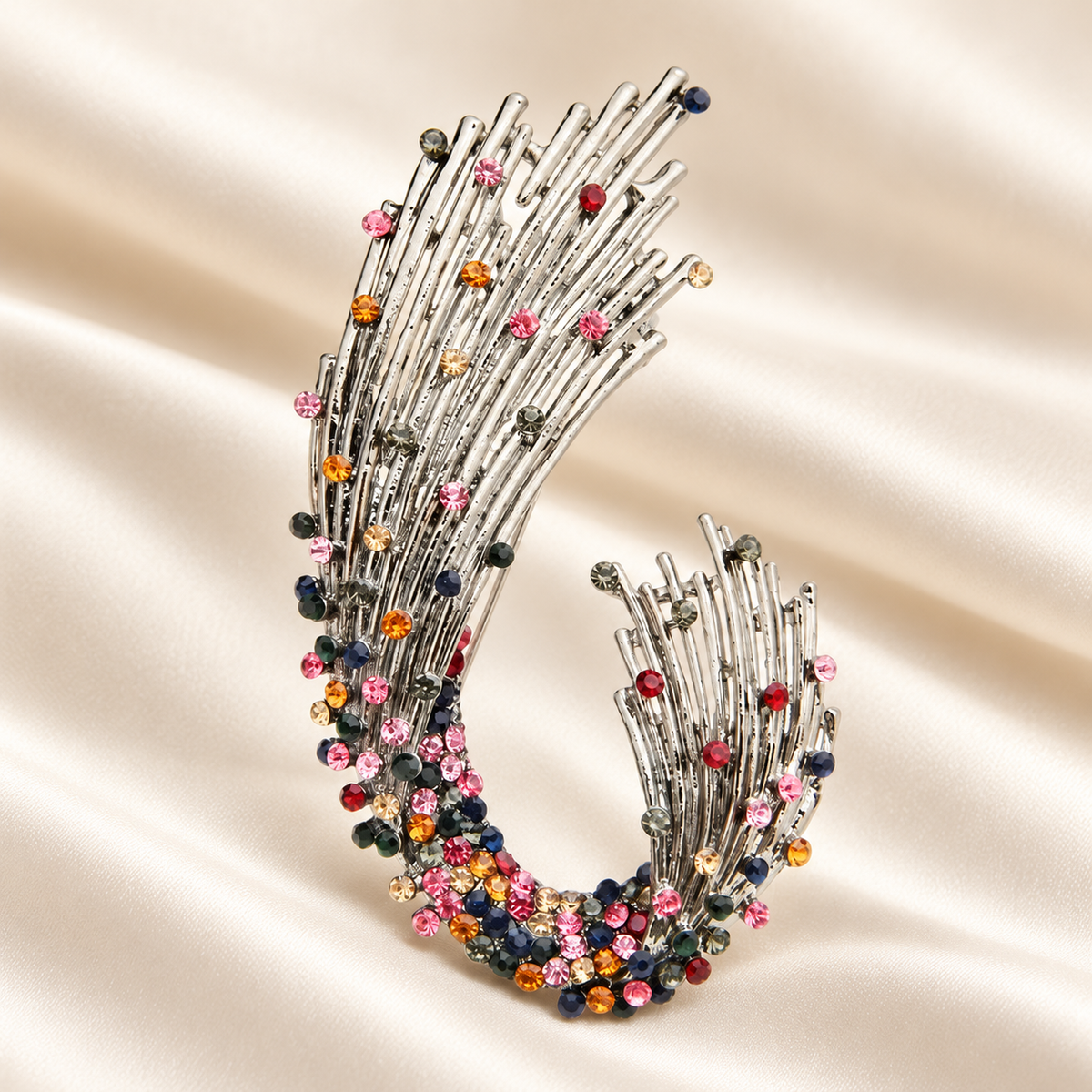 Sweeping Multicolor Rhinestone Spray Brooch — styled background