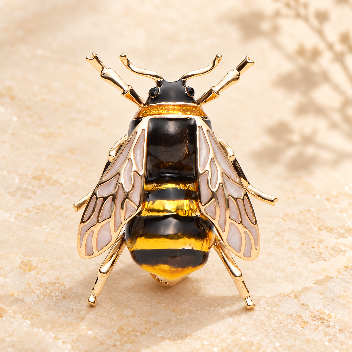 Detailed Black and Yellow Enamel Bee Brooch — styled background