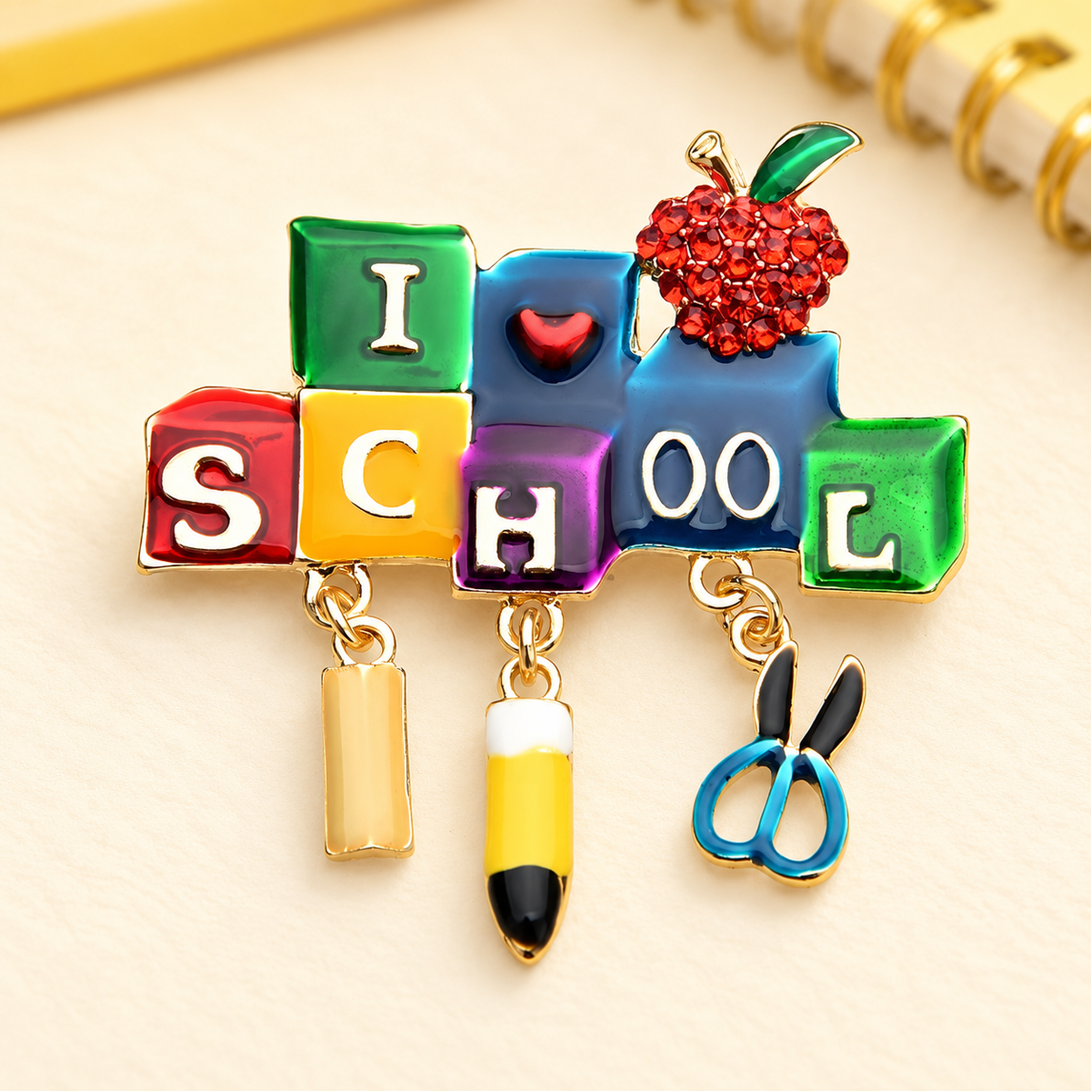 School Letters with Pencil and Apple Brooch — styled background