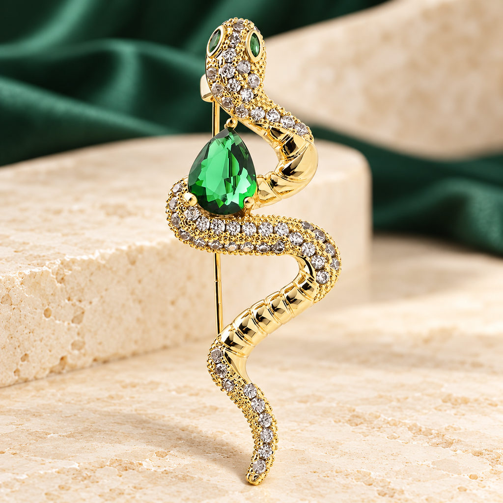 Coiled Snake with Green Teardrop Brooch — styled background