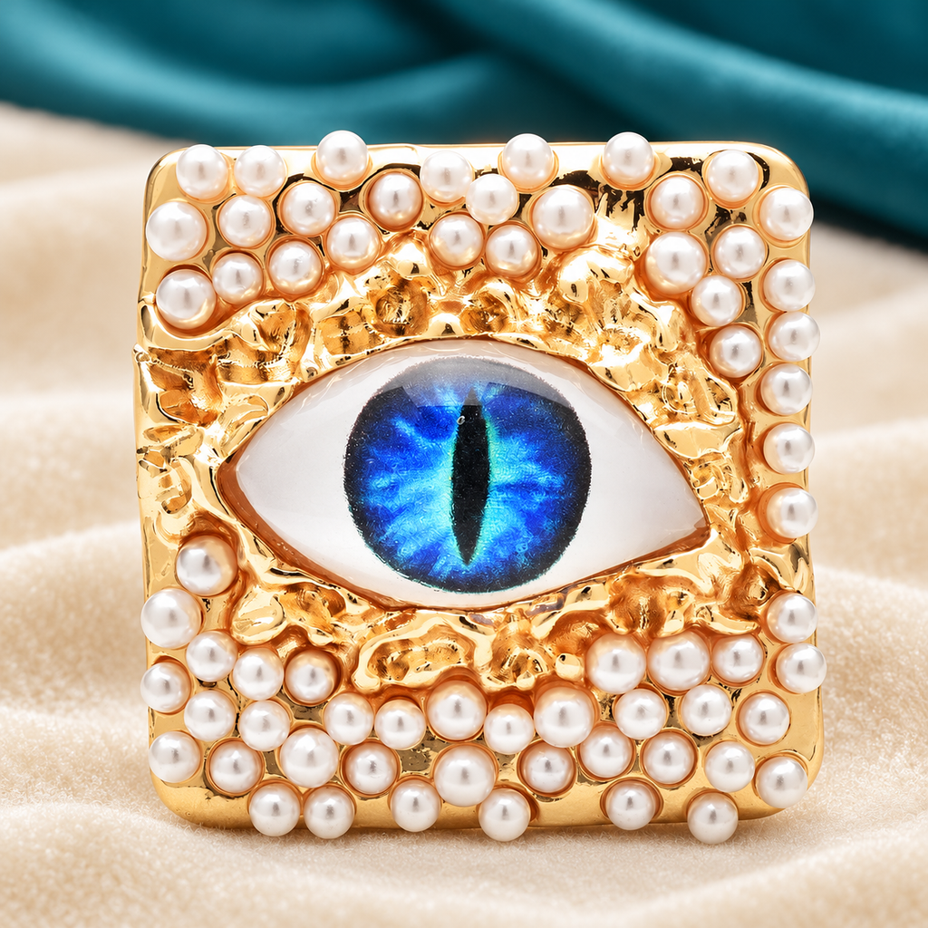 Pearl-Look Square Frame with Colorful Eye Brooch — styled background