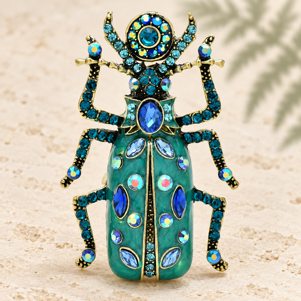 Ornate Enamel Beetle with Faceted Accents Brooch — styled background