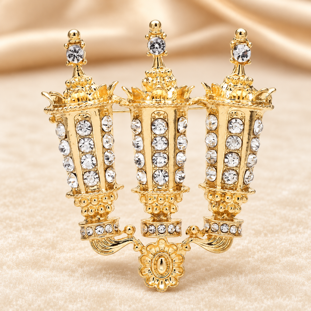 Rhinestone Three-Arm Candle Holder Brooch — styled background