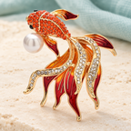 Flowing Rhinestone Goldfish with Pearl-Look Accent Brooch — styled background