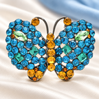 Sparkling Rhinestone Butterfly with Golden Body Brooch — styled background